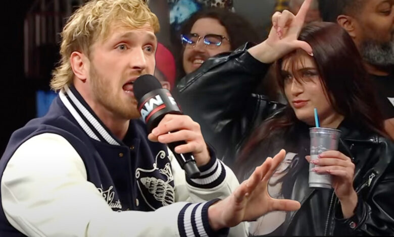 Jake Paul talking to camera in white t-shirt with mic