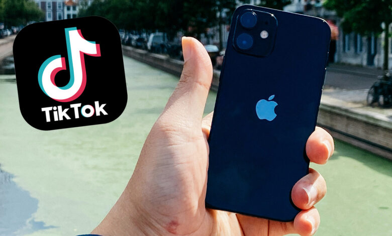 TikTok logo next to an iPhone